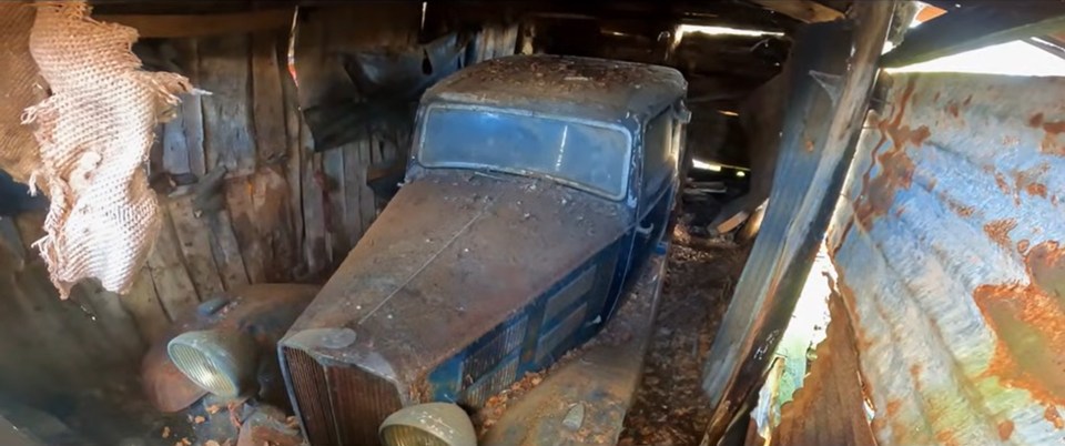 Rusty 1934 car found abandoned in a barn.