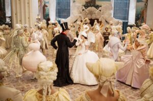 Snow White and the Prince meet in a ballroom, where everyone is dressed in an over-the-top ballgown styled like an animal. Everything is in shades of white and cream, except for the Prince, who wears a black suit and tophat with rabbit ears. Snow White’s dress is styled like a swan, complete with a swan hat. From Mirror Mirror.