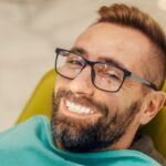 patient at dentist office in chair with smile