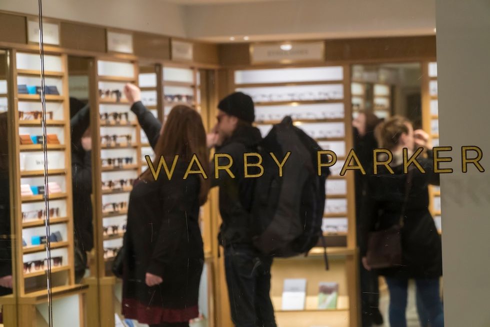 view of shoppers in Warby Parker through a storefront window