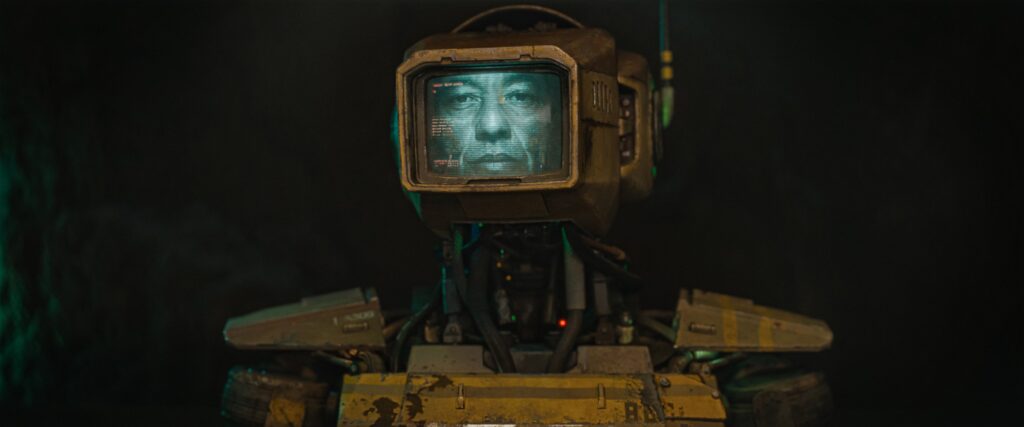 A humanoid robot with a monitor for a head displaying an actual human face.