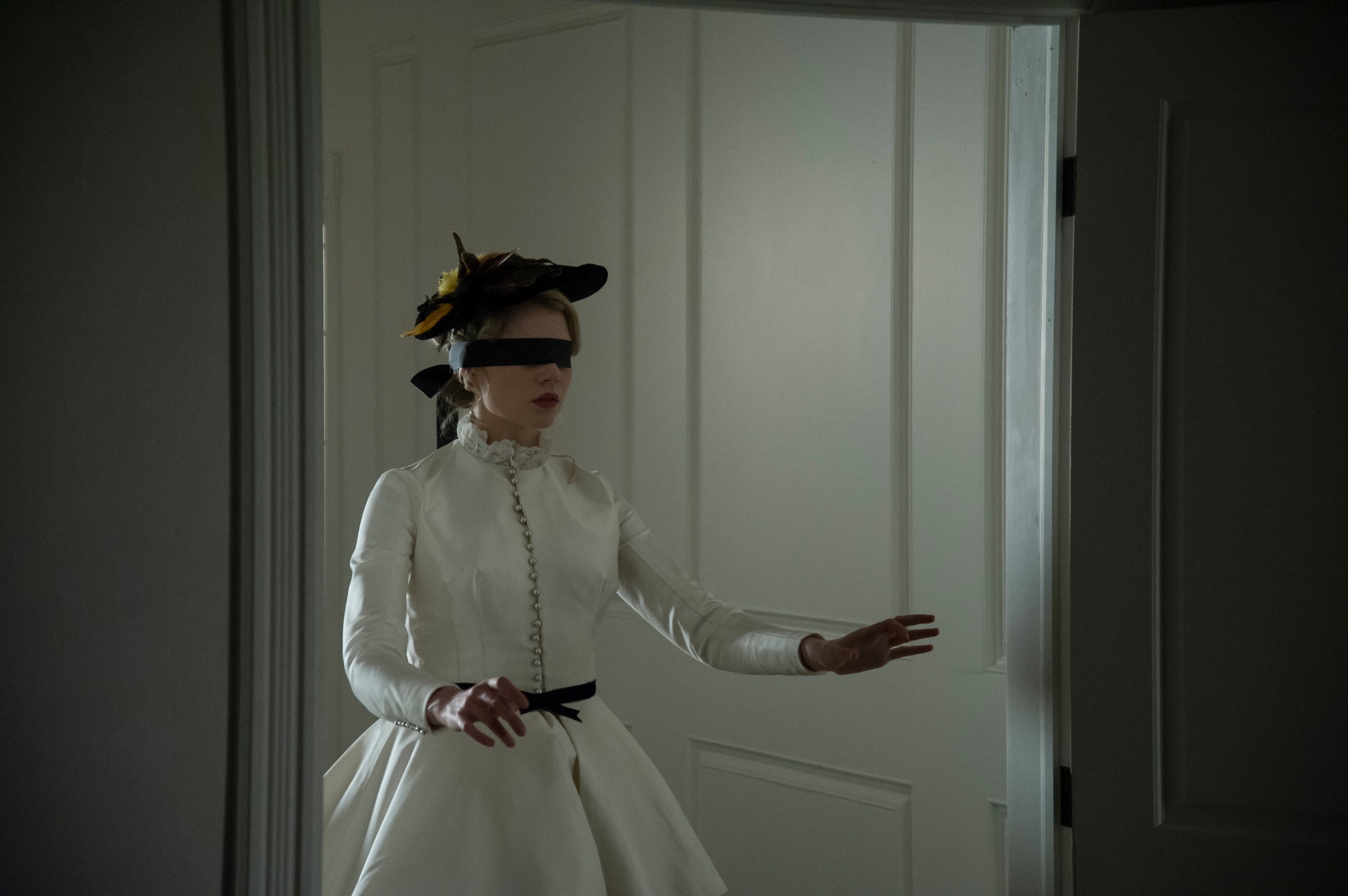 I am the Pretty Thing that Lives in the House - blindfolded woman in white dress walking through a door