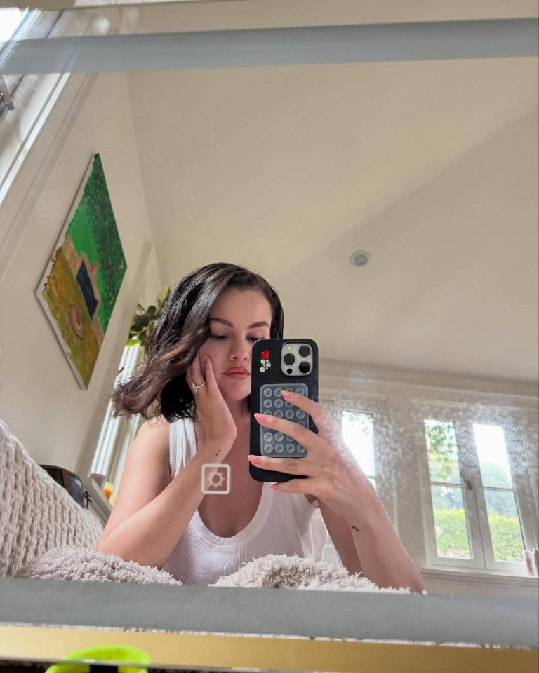 Woman taking a selfie in a mirror.