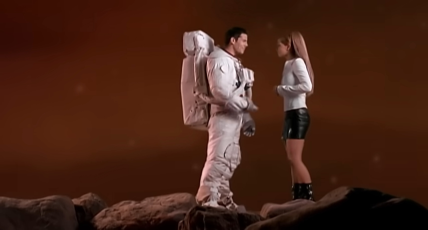 Astronaut and woman on a rocky planet.