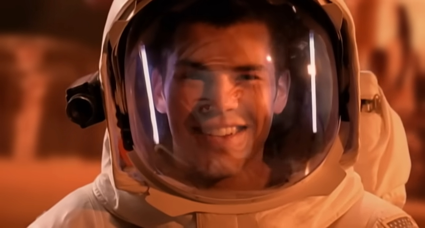 Smiling astronaut in a spacesuit.