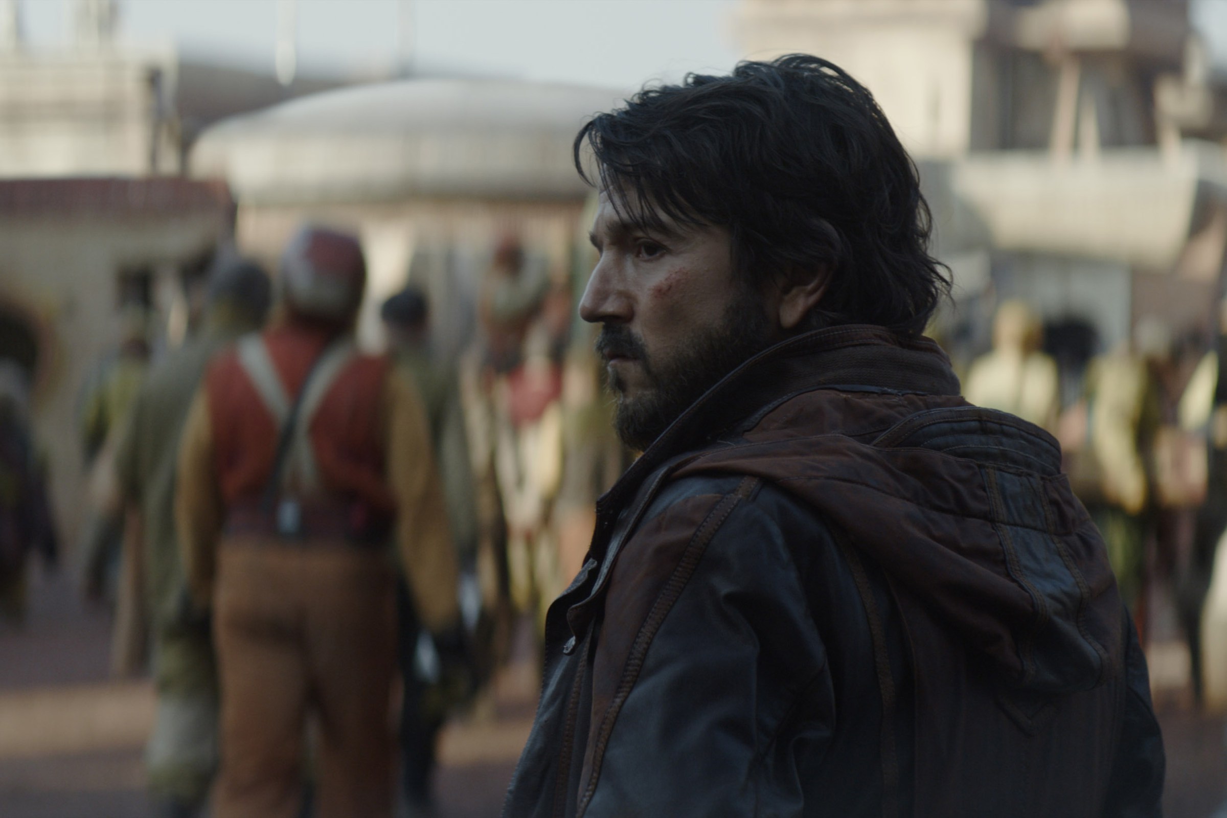 Cassian Andor looks furtively over his left shoulder as he blends in with a team of miners going on shift.