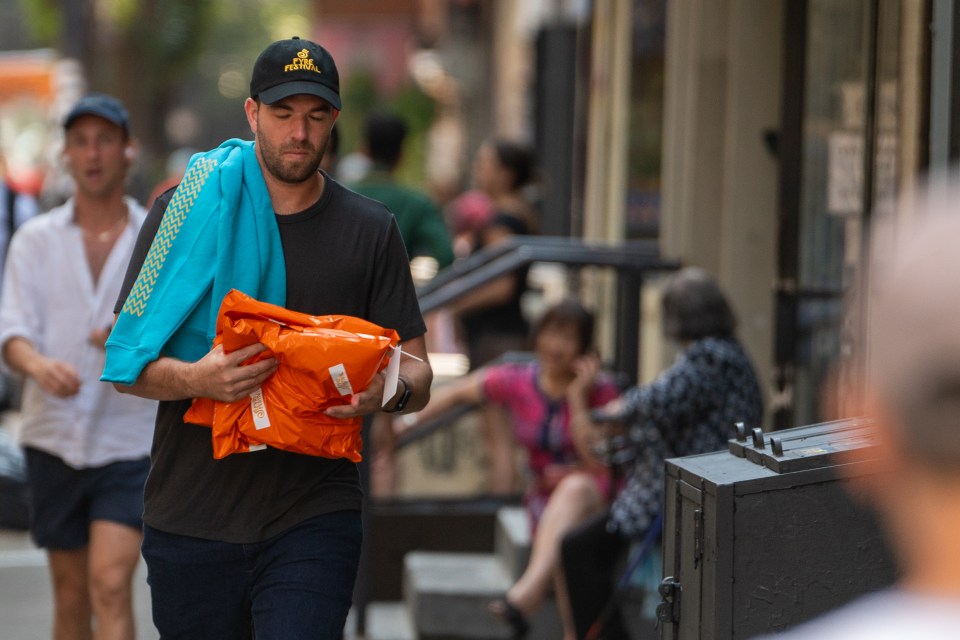 Billy McFarland, Fyre Festival co-founder, carrying packages in New York City.