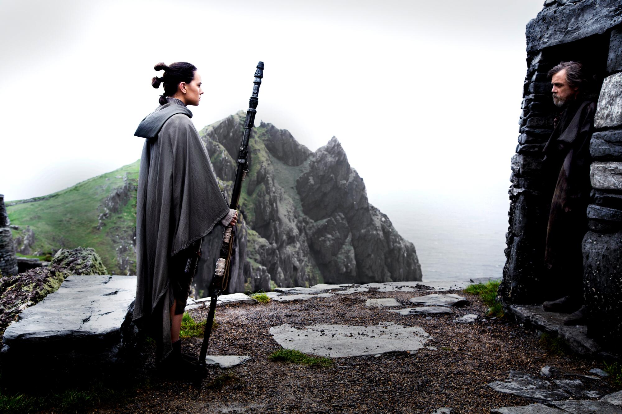 A young woman approaches a former Jedi in exile.
