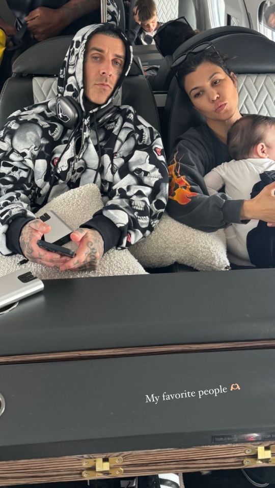 Travis Barker, Kourtney Kardashian, and their baby on a private plane.
