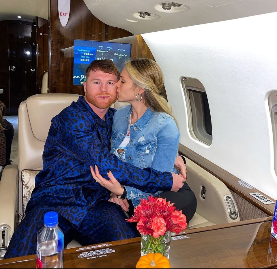 Canelo and Fernanda Gomez embracing on a private jet.