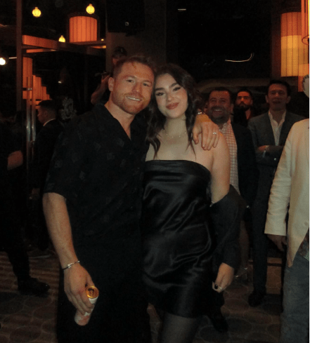 A man and woman in black attire at an event.