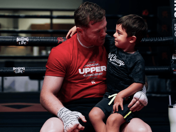 Man holding a young boy on his lap.