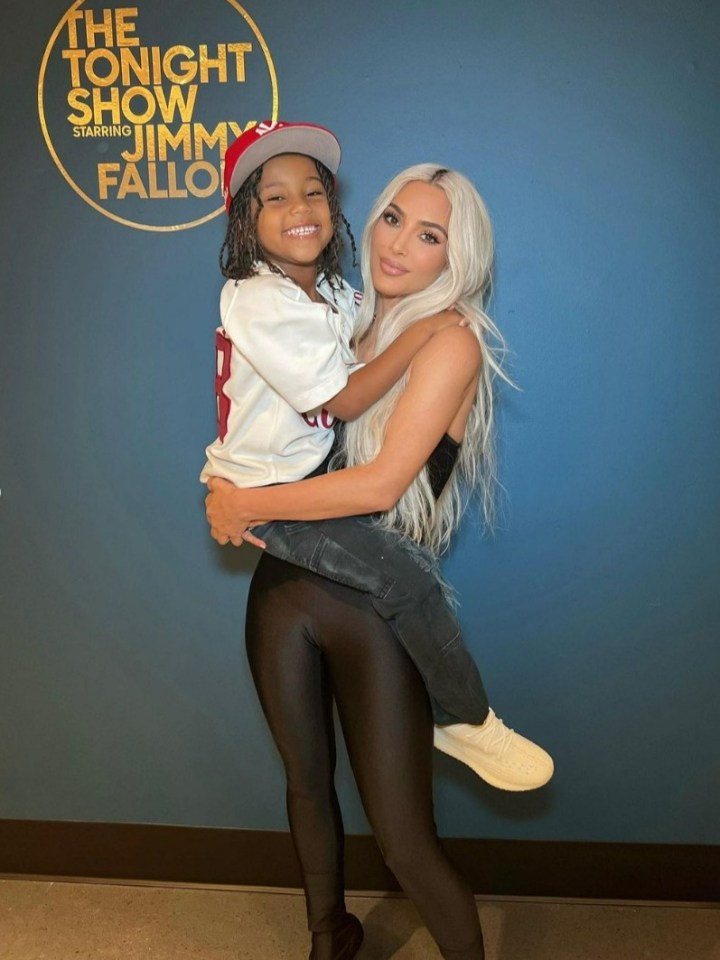 Kim Kardashian holding a young child.