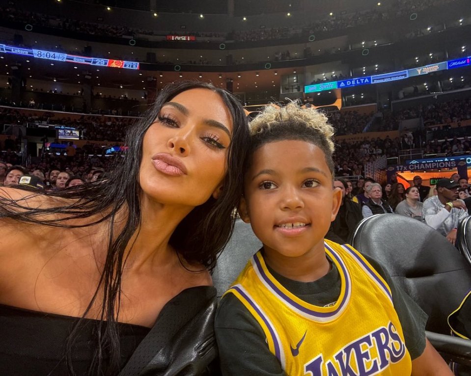 Kim Kardashian and her son at a Lakers basketball game.