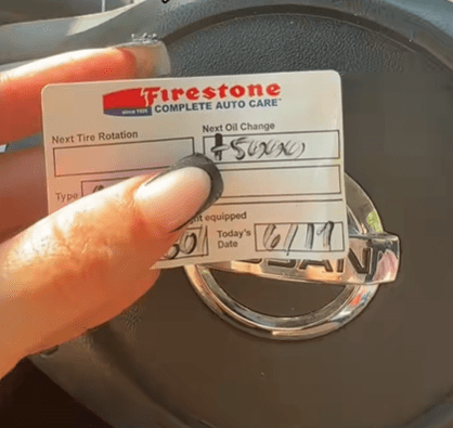 Firestone Complete Auto Care reminder card showing next oil change date.