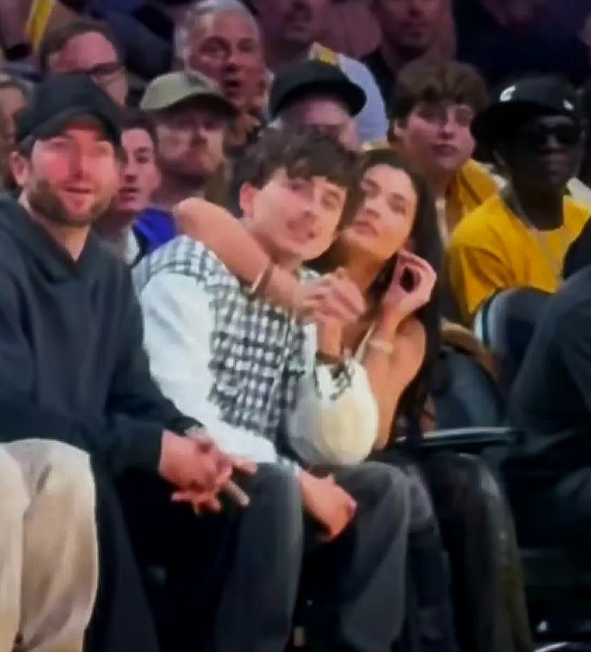 Kylie Jenner and Timothée Chalamet kissing courtside at a Lakers game.