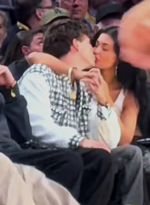 Kylie Jenner and Timothée Chalamet kissing courtside at a Lakers game.