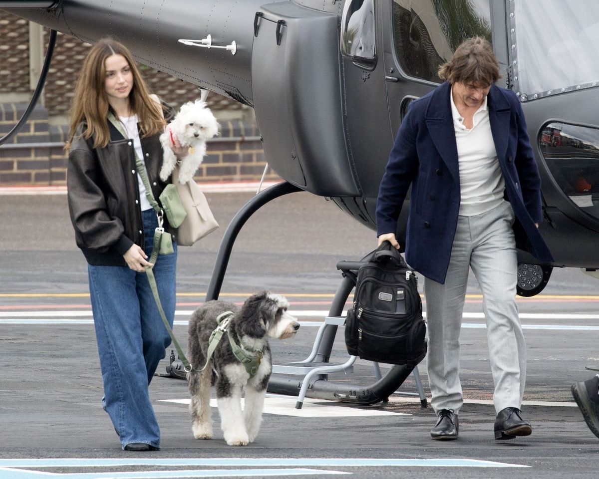 Ana de Armas, her dogs, and Tom Cruise getting out of a private helicopter
