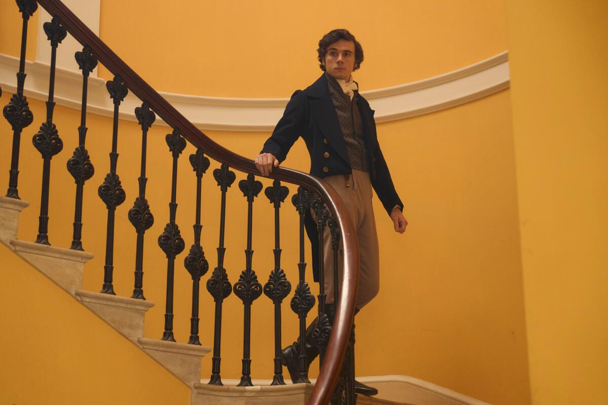 A man in period costume descends a curving staircase in "Miss Austen."