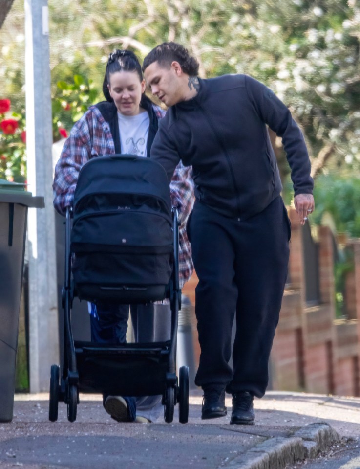 Anne-Marie and Slowthai pushing a baby stroller.