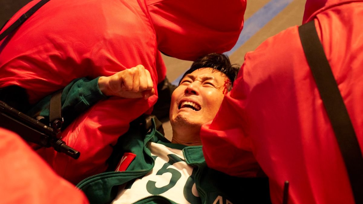 Gi-hun in Squid Game season 3 trailer being drug off by guards
