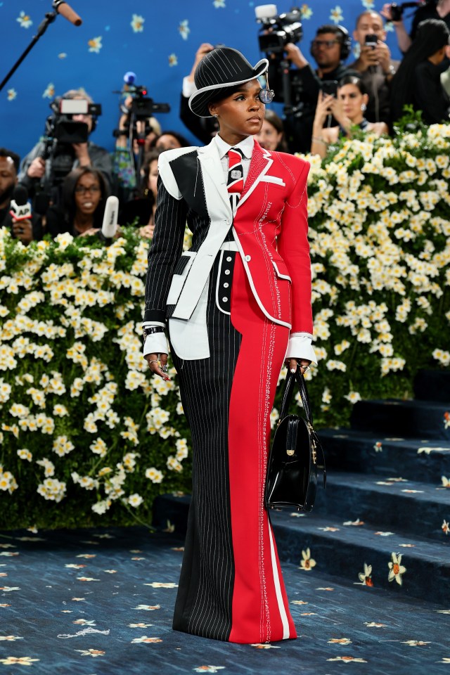 Janelle Monáe at the Met Gala in a red and black pinstripe suit.