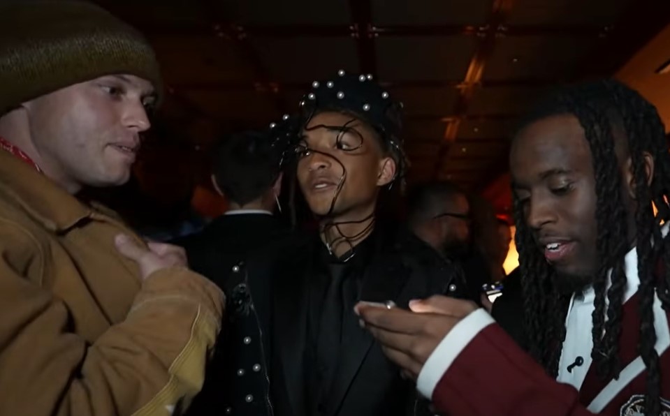 Three men talking at an after-party.