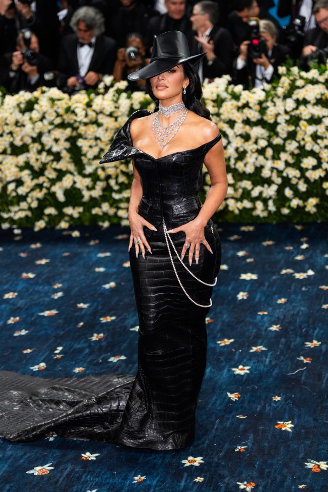 Kim Kardashian at the Met Gala in a black crocodile-skin outfit.