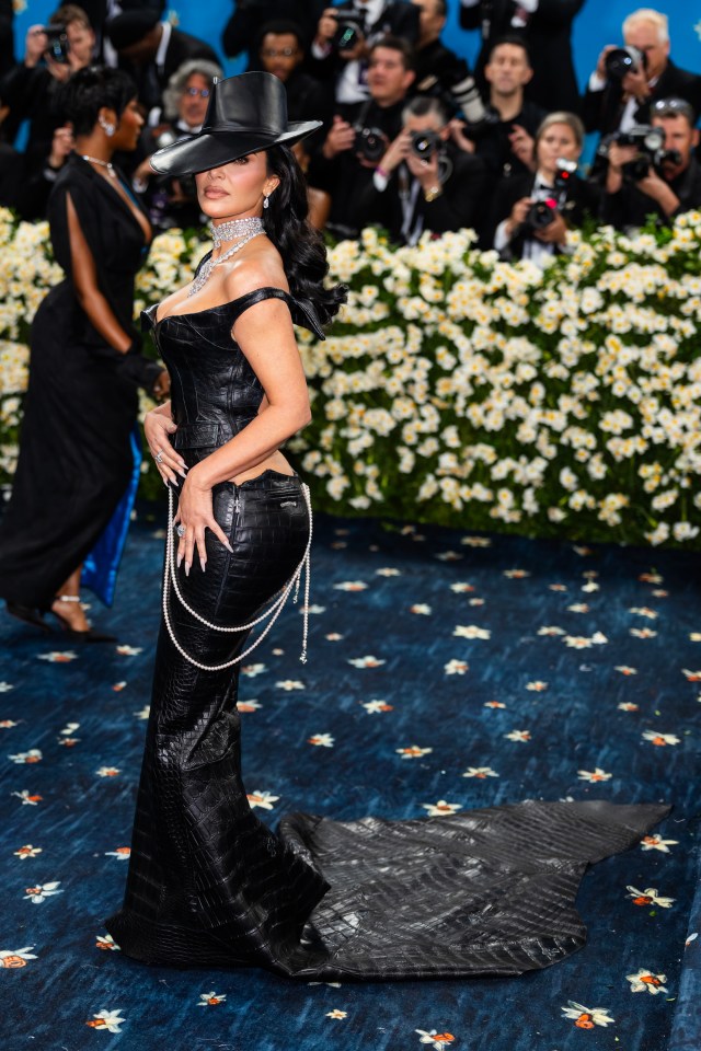 Kim Kardashian at the Met Gala in a black crocodile-skin outfit.