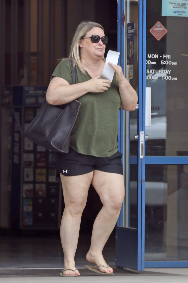 Brooke Thompson, aka "Pumpkin," carrying items near her vehicle.