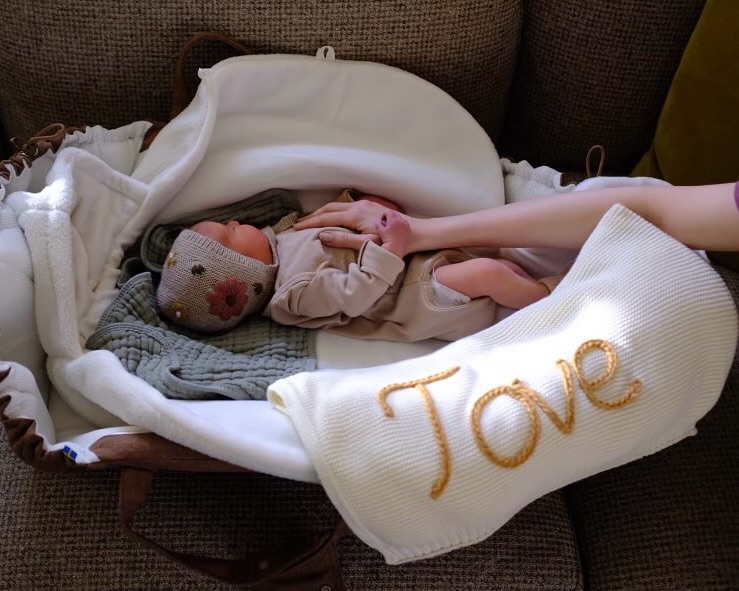 Baby Tove in a bassinet.