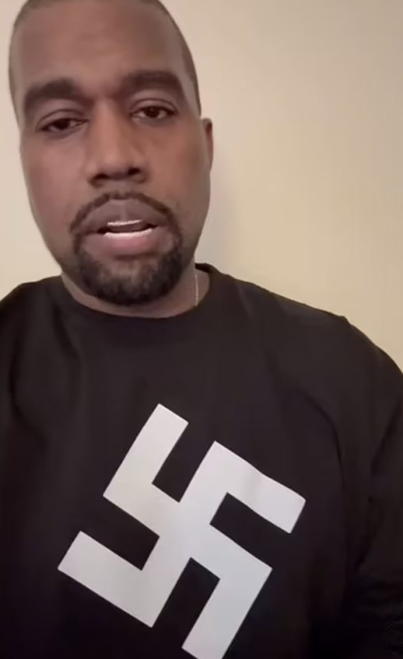 Kanye West wearing a shirt with a swastika.