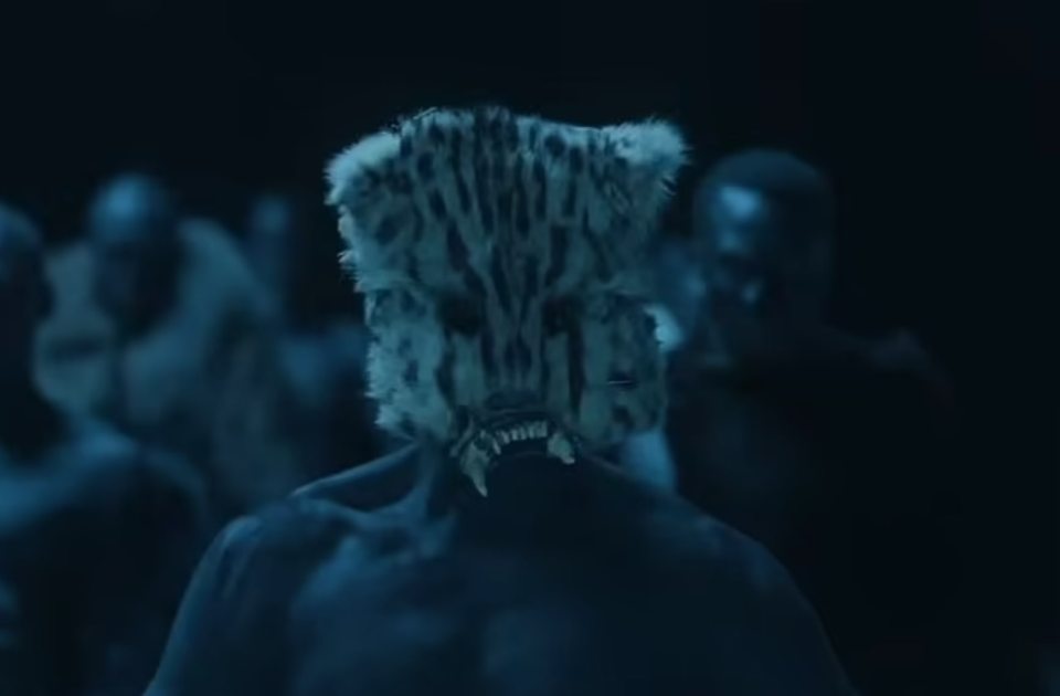 Screenshot from Kanye West's music video showing a person wearing an animal mask.