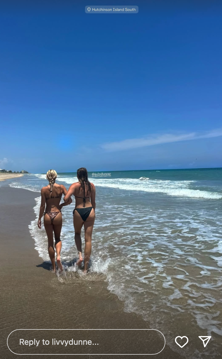 Olivia Dunne links arms with her sister Julz at the beach.