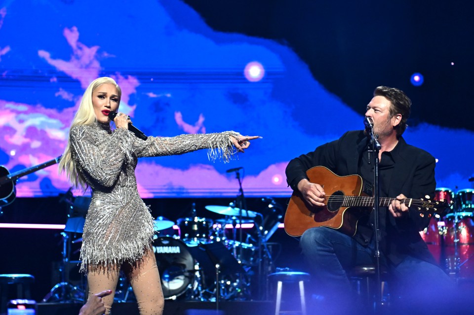 Gwen Stefani and Blake Shelton performing onstage.