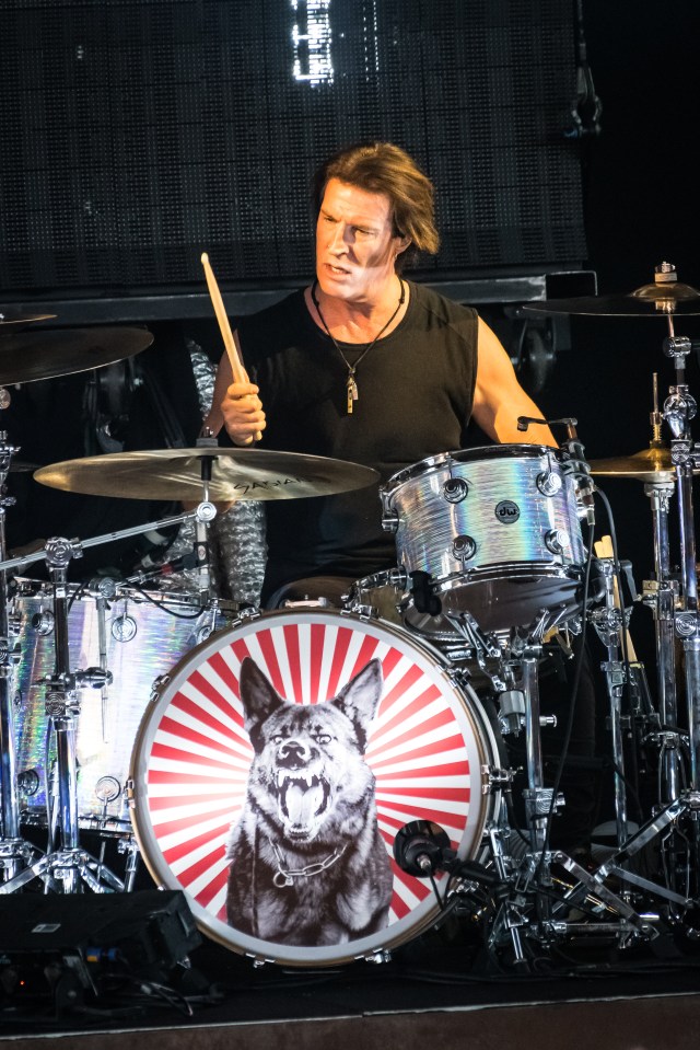 Sean Kinney of Alice in Chains performing at a concert.
