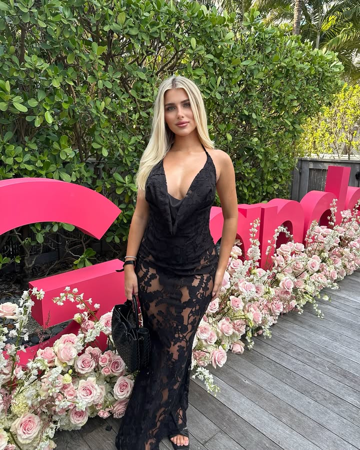 Woman in black lace dress at an event.