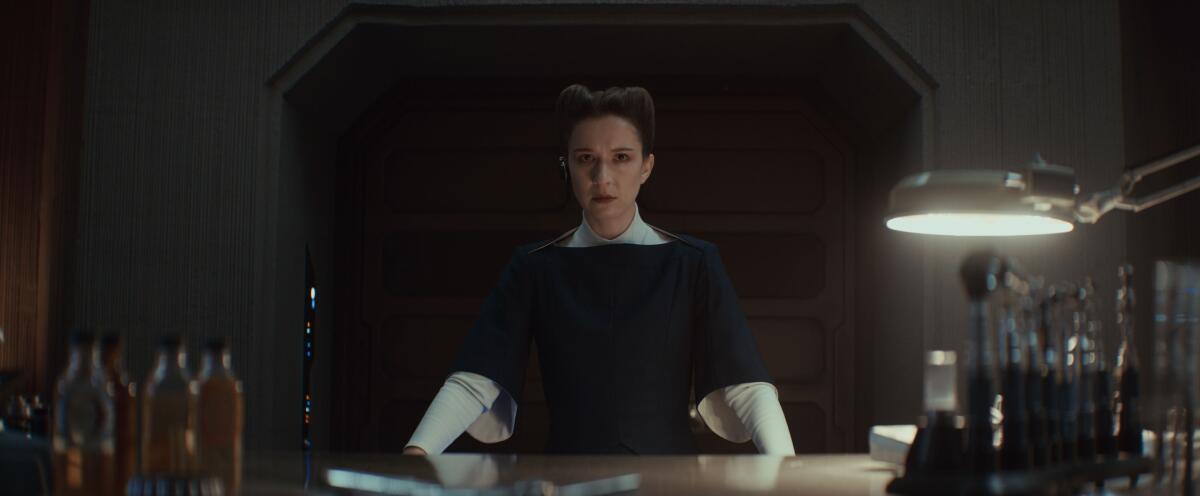 a woman standing behind a desk