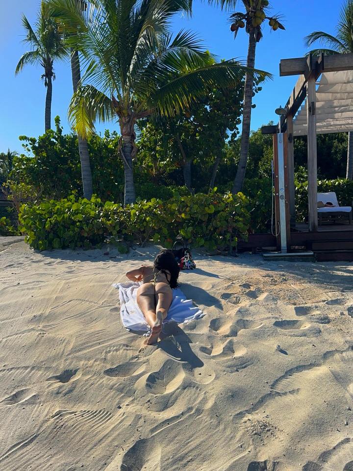 Woman sunbathing on a beach.