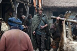 Ser Duncan the Tall in raggedy clothes walks through a market in A Knight of the Seven Kingdoms