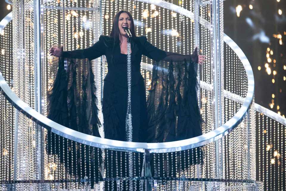 Singer performing on a crystal stage at the Eurovision Song Contest.