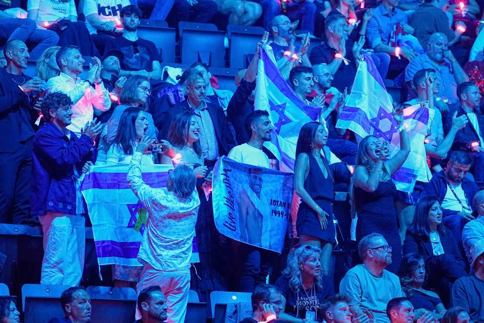 Israeli fans waving flags and cheering at the Eurovision Song Contest.