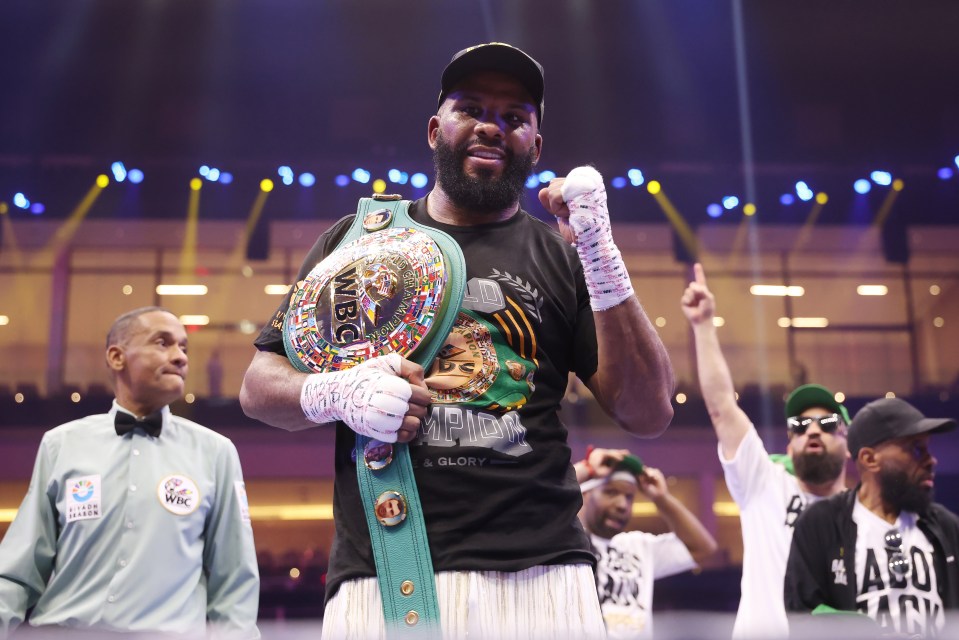 Badou Jack holding the WBC World Cruiserweight title belt after a boxing match.