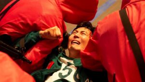 Gi-hun in Squid Game season 3 trailer being drug off by guards