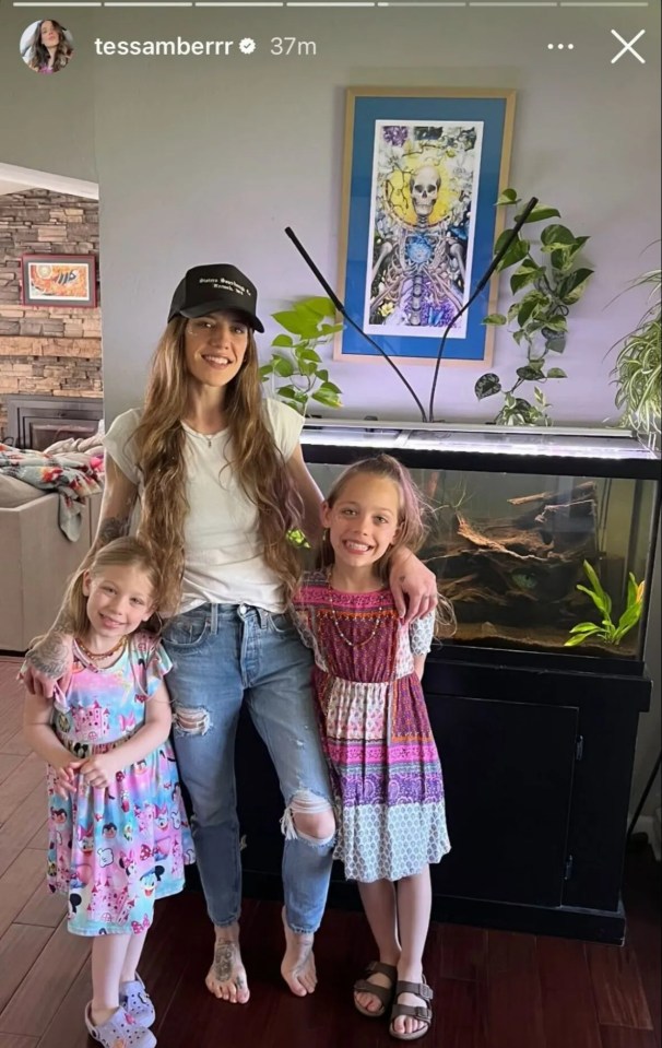 A woman and her two daughters pose for a photo.