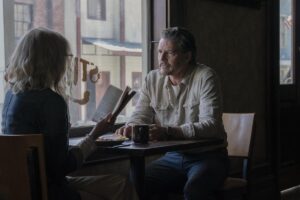 A woman and a man seated at a diner table.