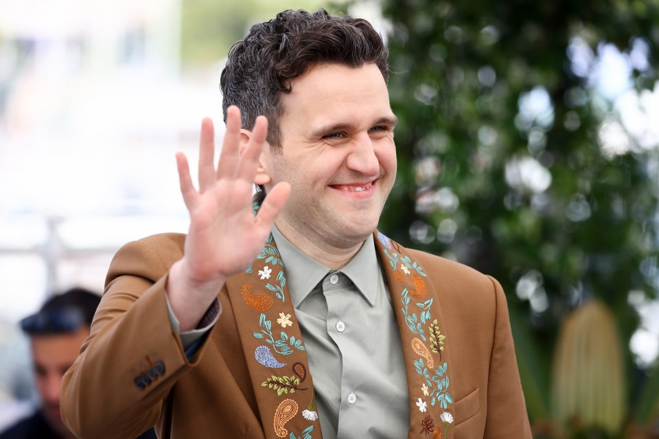 Harry Melling waving at the Cannes Film Festival.