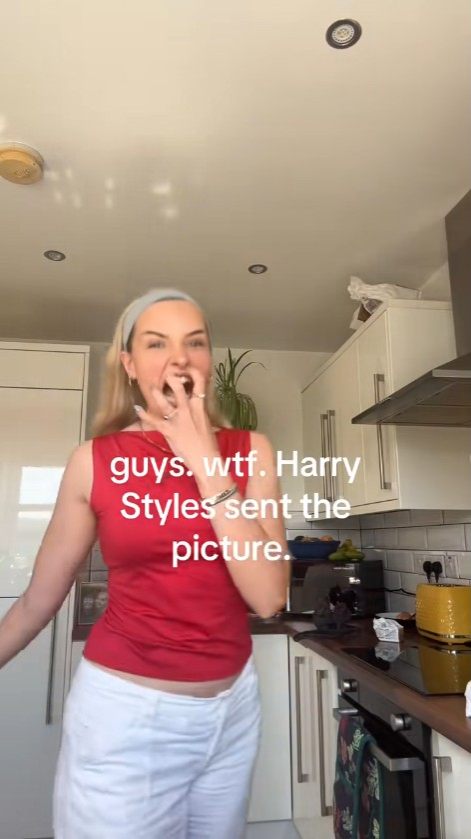 Woman reacting with shock in her kitchen; text overlay says Harry Styles sent her a picture.