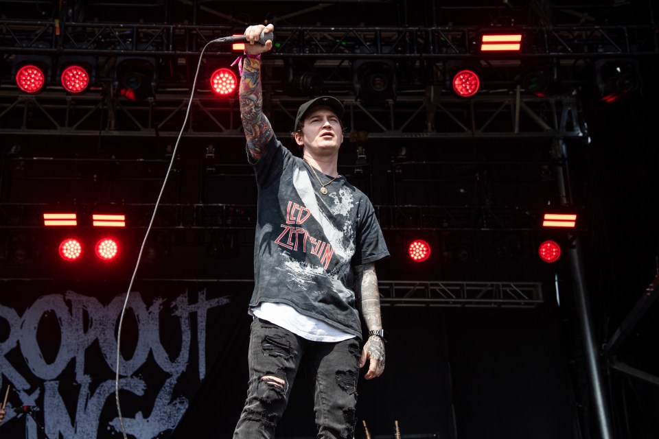 Adam Ramey of Dropout Kings performing on stage.