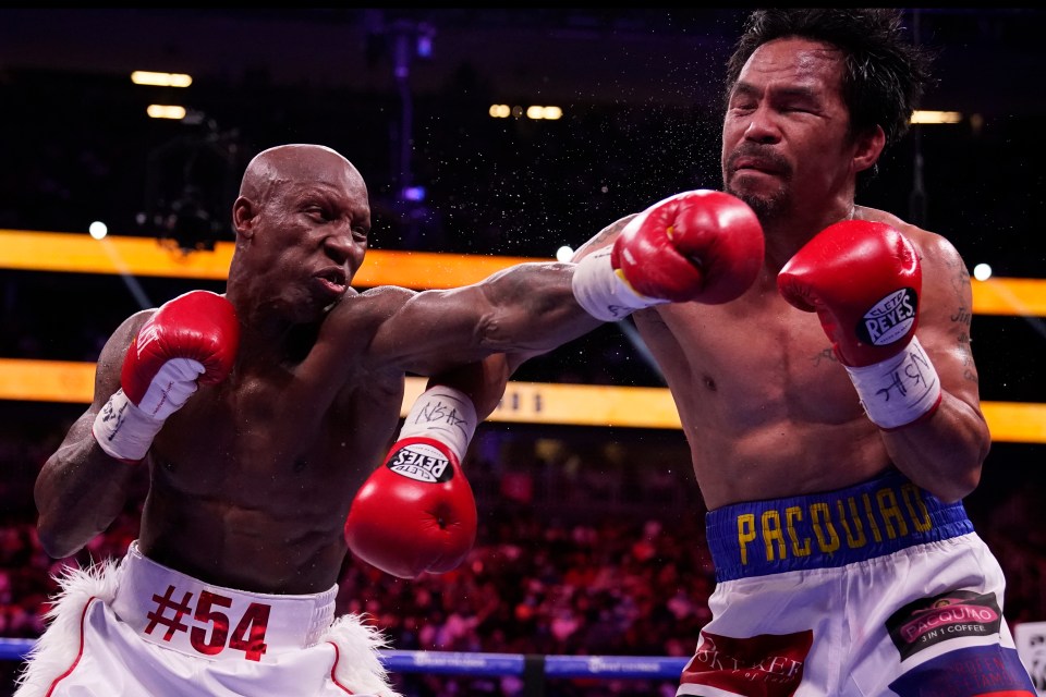 Yordenis Ugas punches Manny Pacquiao in a boxing match.